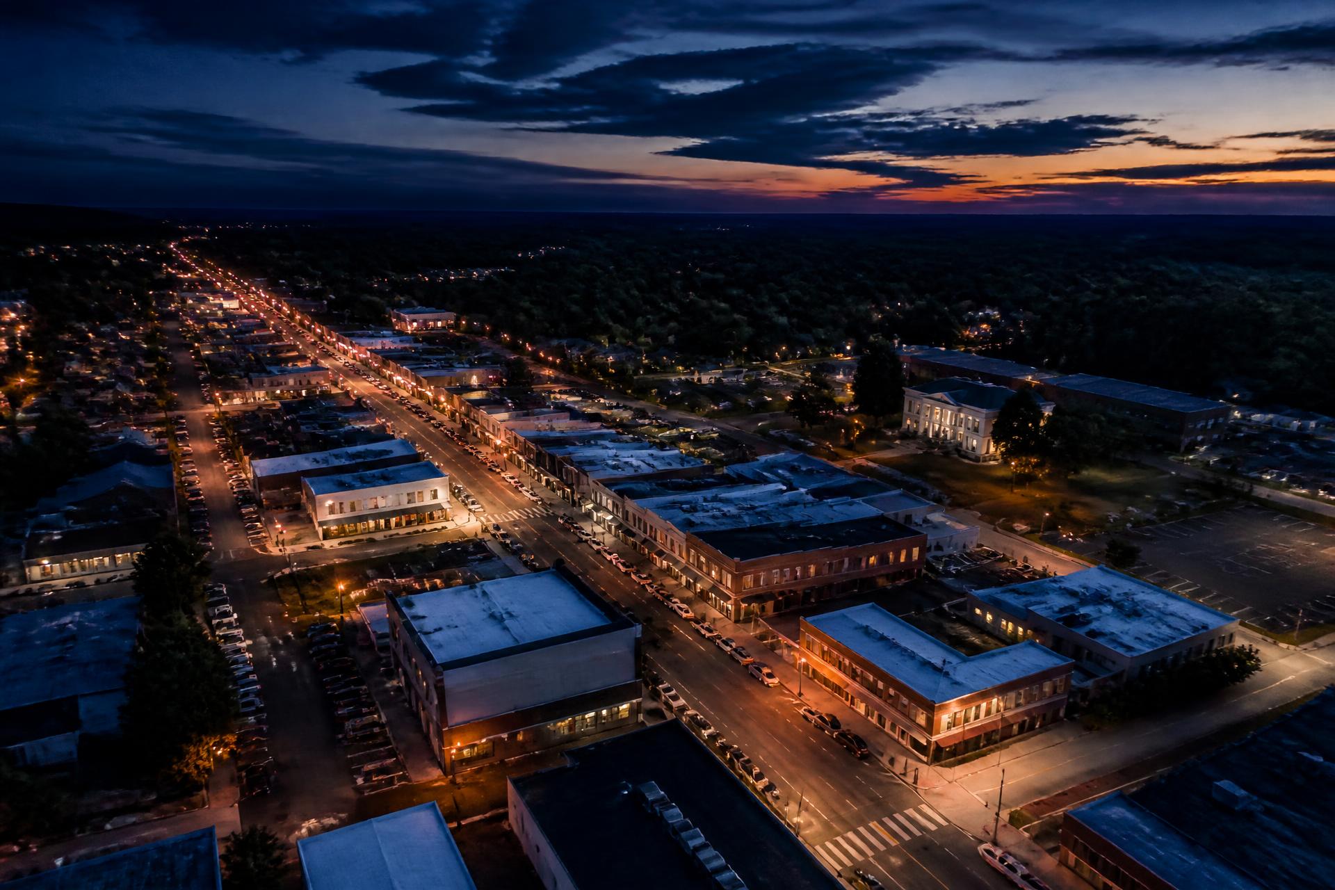 Aerial view of a small Arkansas downtown business district at dusk
